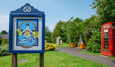 Biddulph Moor village green, with village sign and red telephone box
