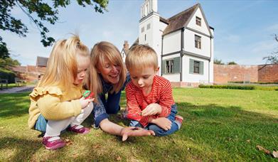 Family exploring the grounds of Boscobel House, South Staffordshire.