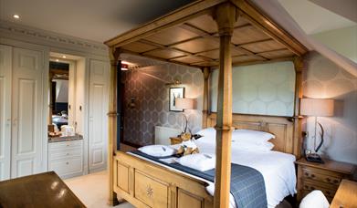 Image shows a four poster bed in one of the rooms at The Moat House