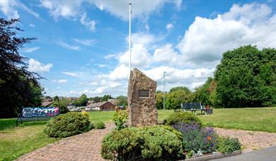 the war memorial rock and flag pole in the village of Werrington