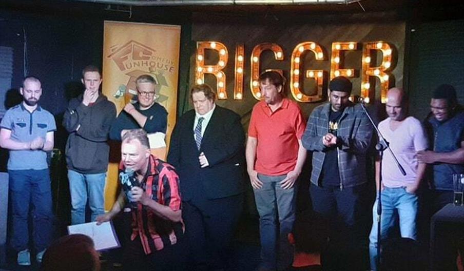 Photo shows stand up comedians on a stage