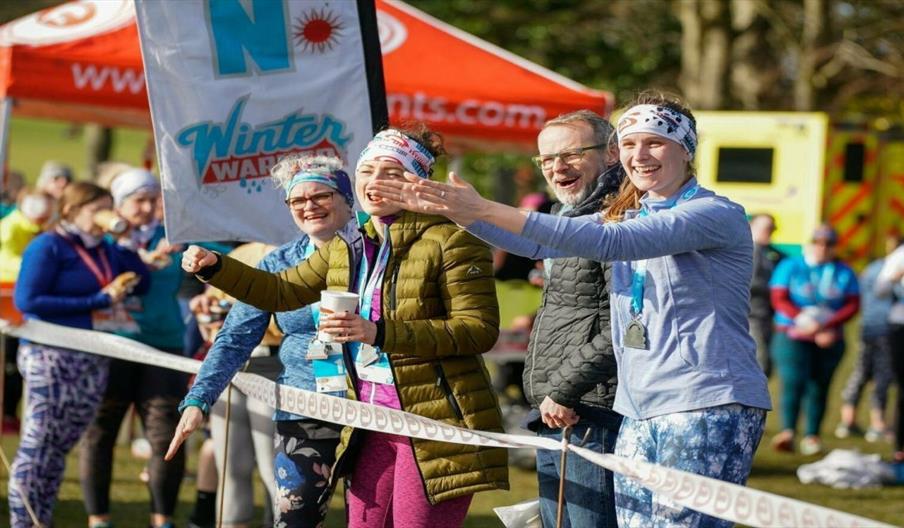 Image shows crowds cheering on the athletes at a running event