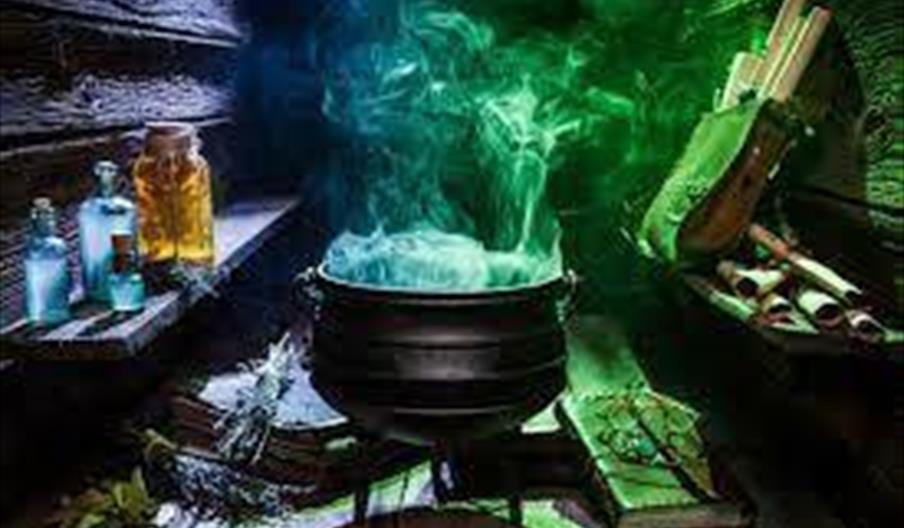 Image shows smoke rising from a cauldron in a spooky laboratory