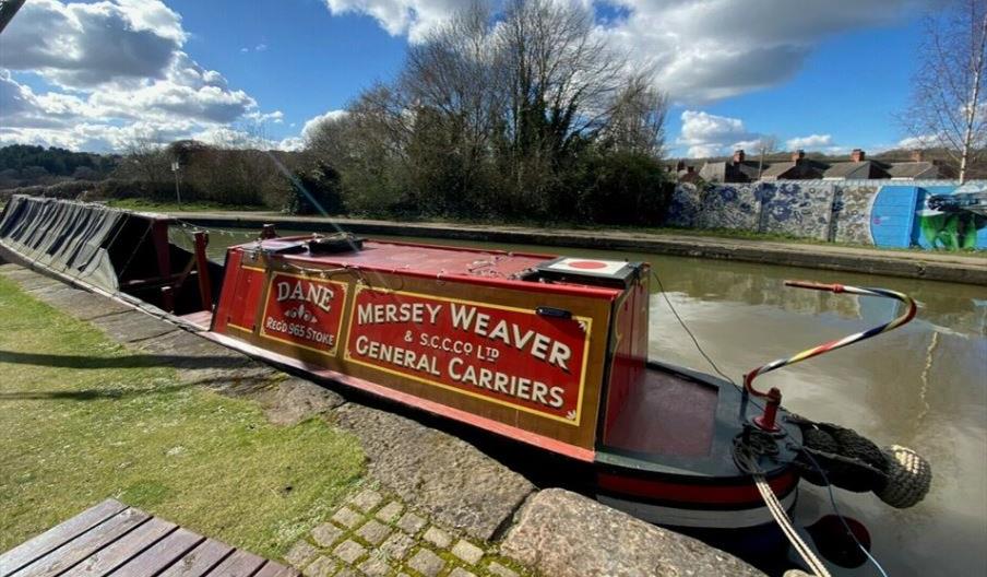 A picture of a narrowboat moored up on a sunny day