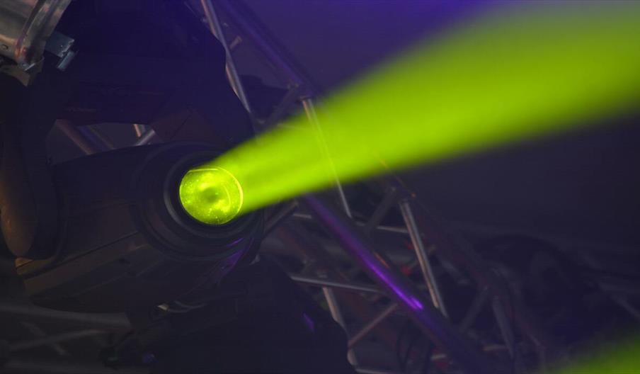 Close-up of green spotlight and stage-lighting rig