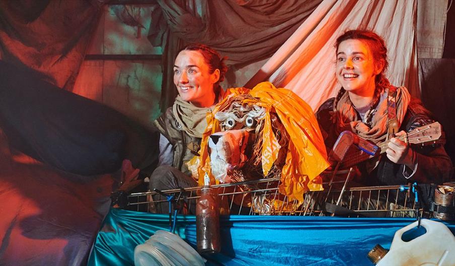 Two actors and a puppet in Stories in the Dust
