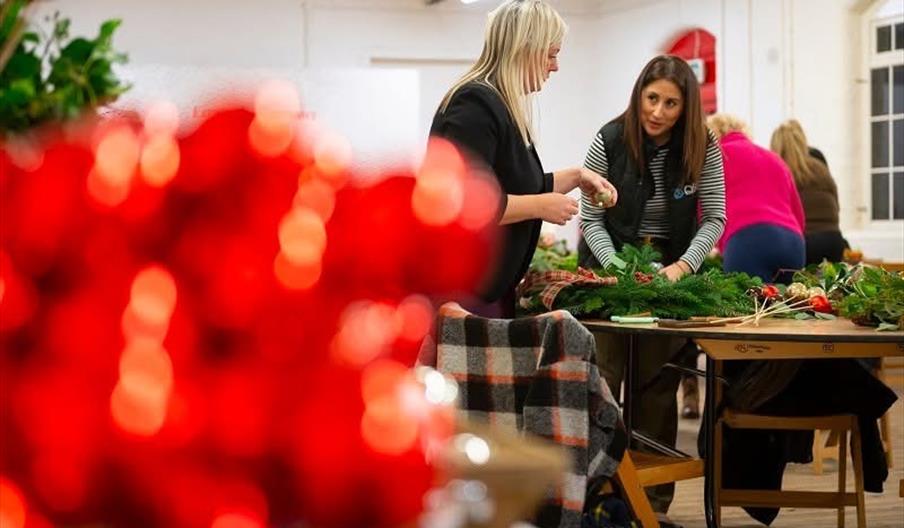 ladies making Christmas wreaths