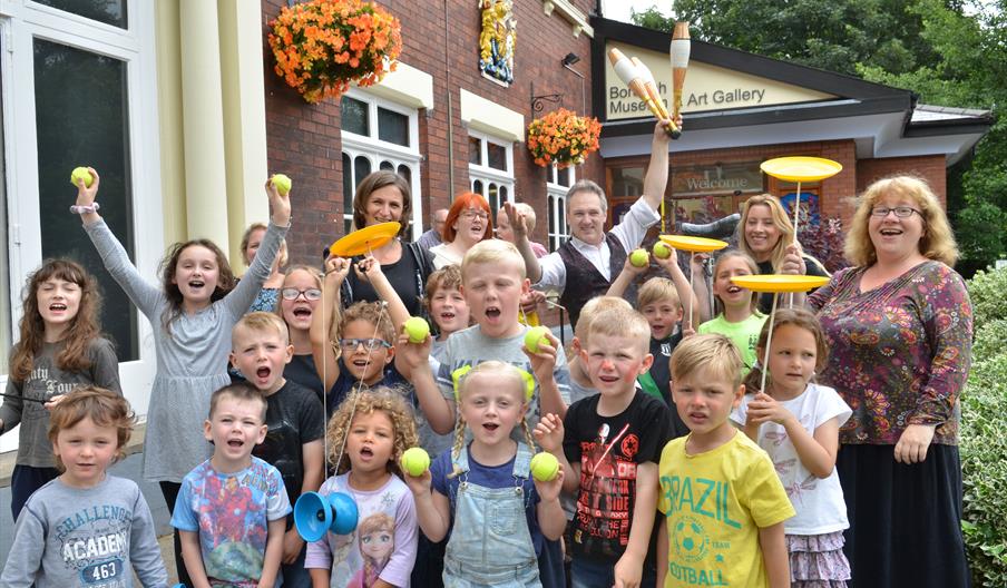 A group of children learn circus skills with the help of Andrew van Buren at Brampton Museum, Staffordshire