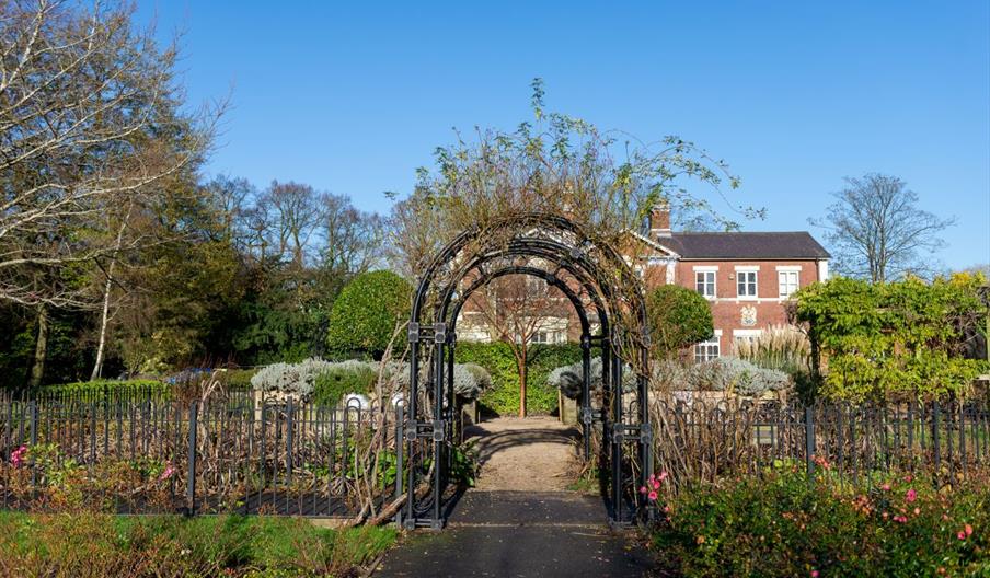 Wrought iron archway with Brampton Museum in the background