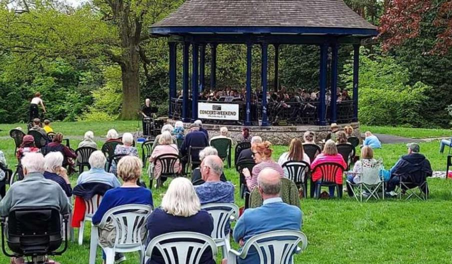image of a concert and audience at a bandstand