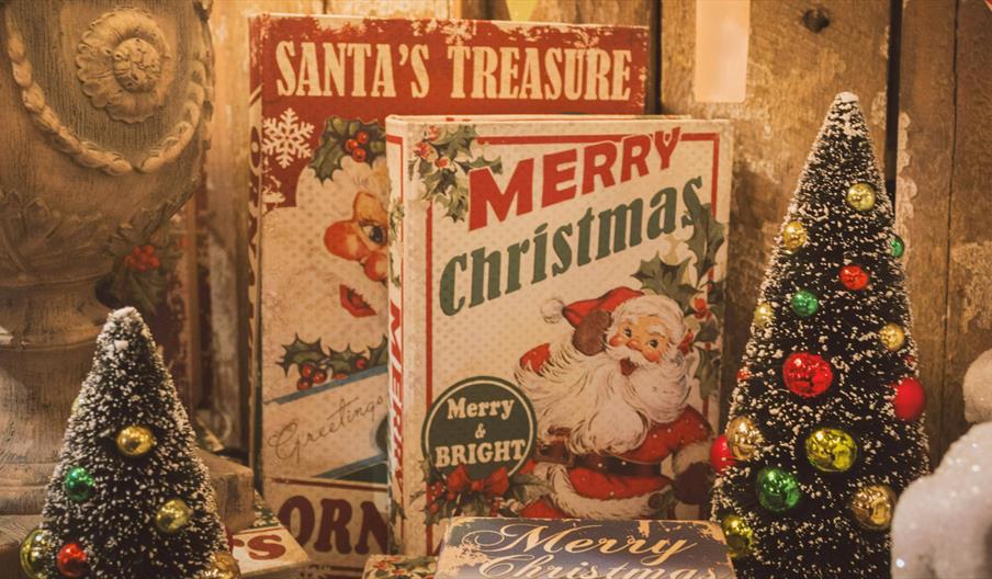 Books with Santa on the front and two tiny Christmas trees