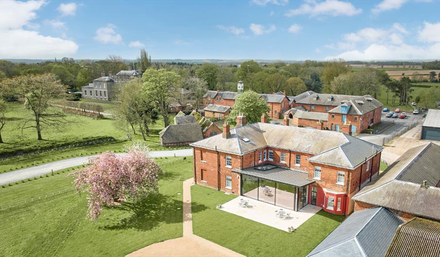 A drone shot of Constantine House and grounds, on a beautiful sunny day