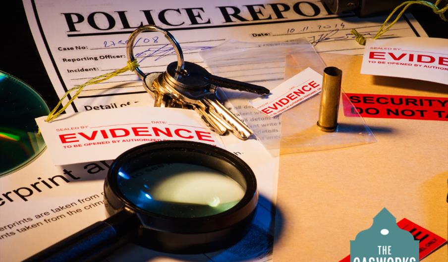 Image shows props from the event, including magnifying glass, keys, and a police report