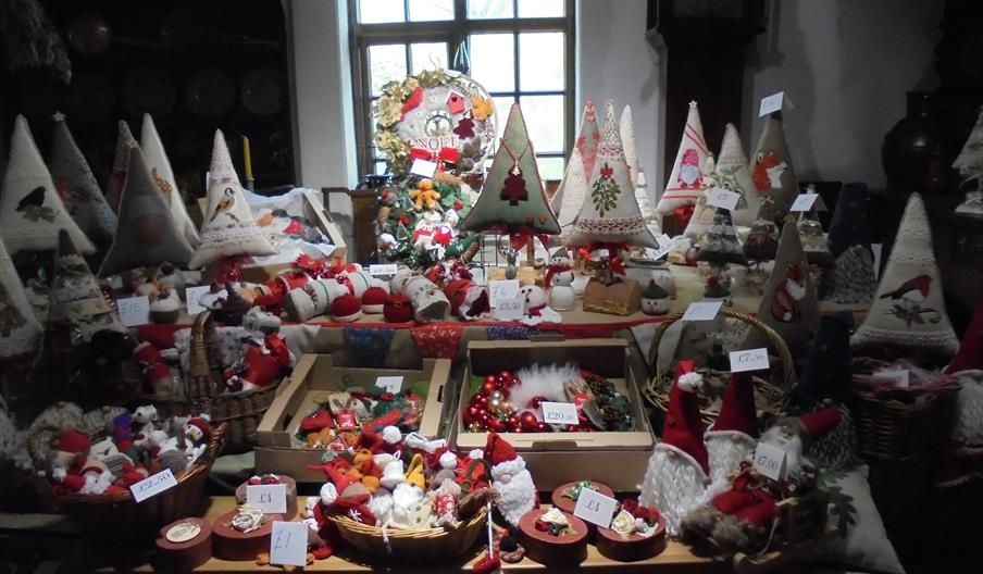 Image shows a table full of Christmas decorations, like the ones you'll be able to buy at the Christmas Craft Fair at Ford Green Hall