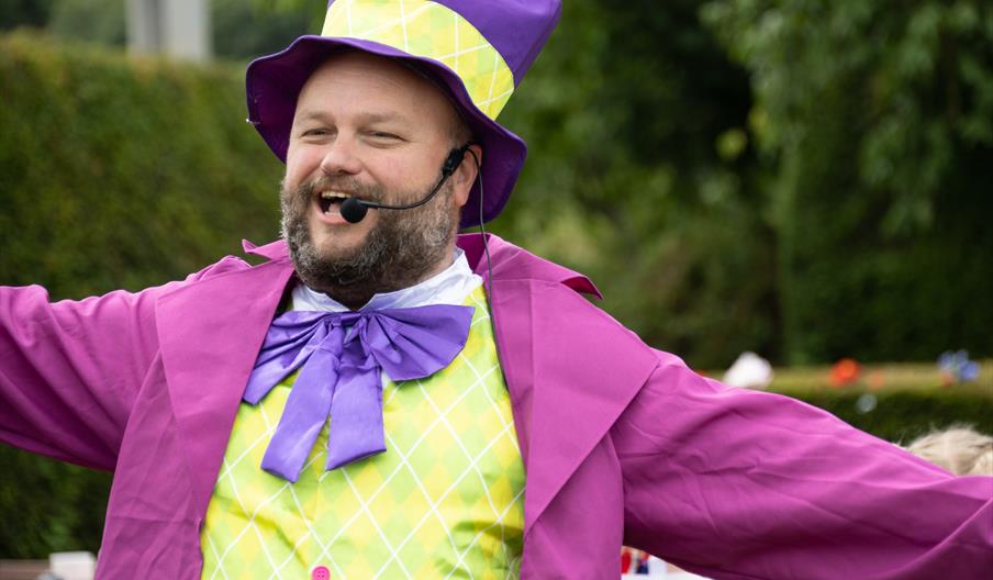 Image shows a man dressed as a character from Alice in Wonderland