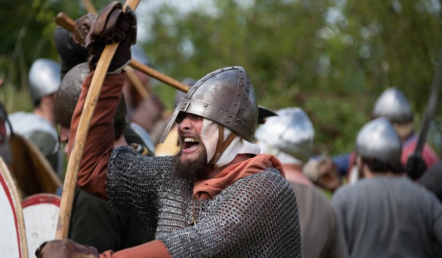 Image shows a man wearing chain mail at a re-enactment