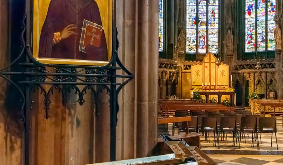 Image shows the interior of Lichfield Cathedral, with the historic stained glass Herkenrode windows in the background