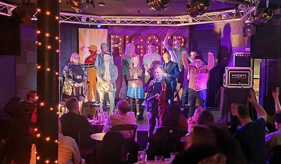 an audience of people watching performers on stage