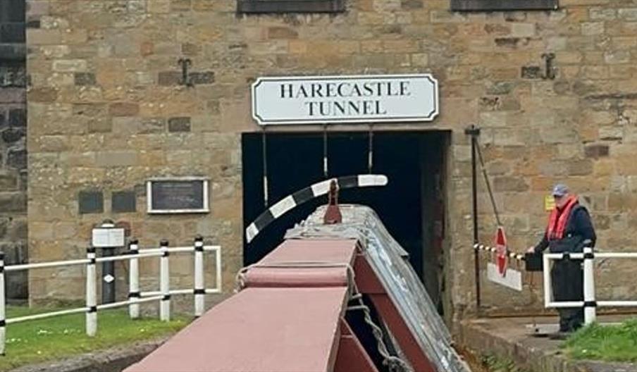 A narrowboat heads into a tunnel