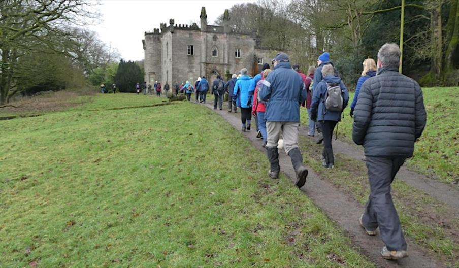 a group of walkers, walking past an house in Rudyard