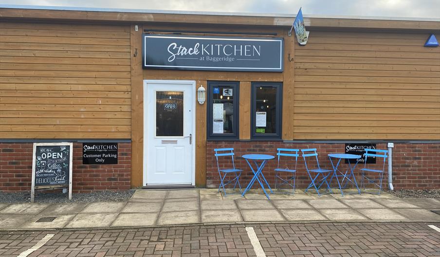 The entrance to Stack, showing some tables and chairs outside