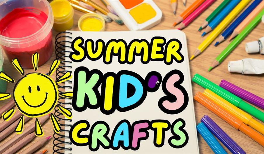 Colourful children's craft poster with paints, pencils and markers surrounding a notebook that reads "Summer Kids' Crafts" with a smiling sun illustra