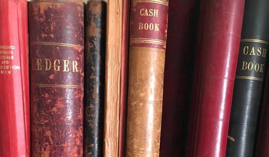 image of Cash and Ledger books on a shelf