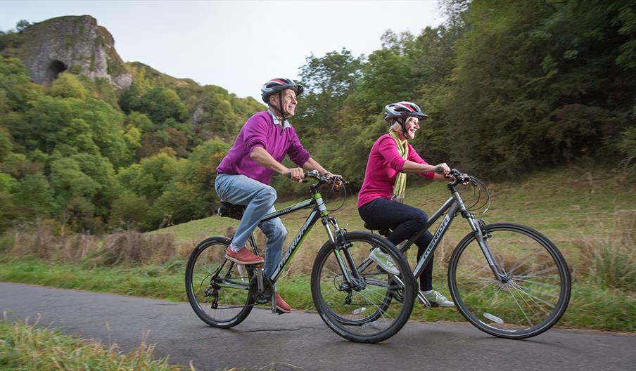 Easy cycling on the Manifold Track with Thor's Cave in the distance.