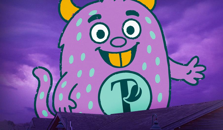 A cartoon of a purple monster with the Trentham logo on the chest, towering over the wooden cabins of Trentham Shopping Village