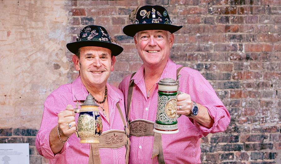 Two people give a "cheers" to the camera