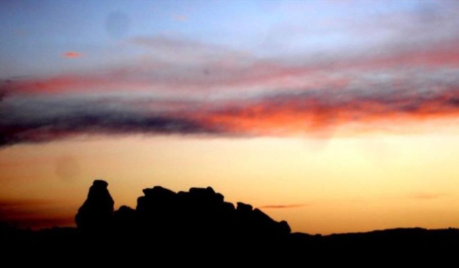 image of a rock silhouette against a sunset