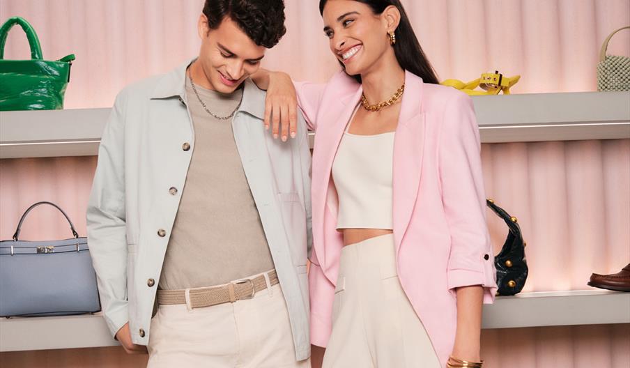A couple smiling in a store at McArthurGlen West Midlands