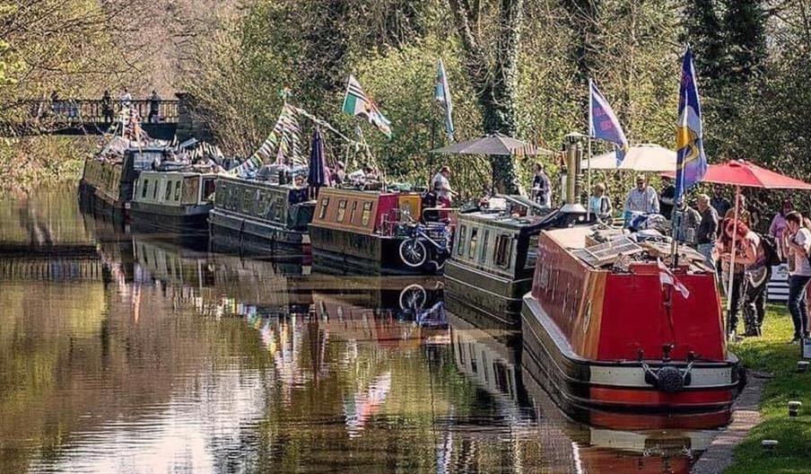 Narrowboats mooring alongside the canal