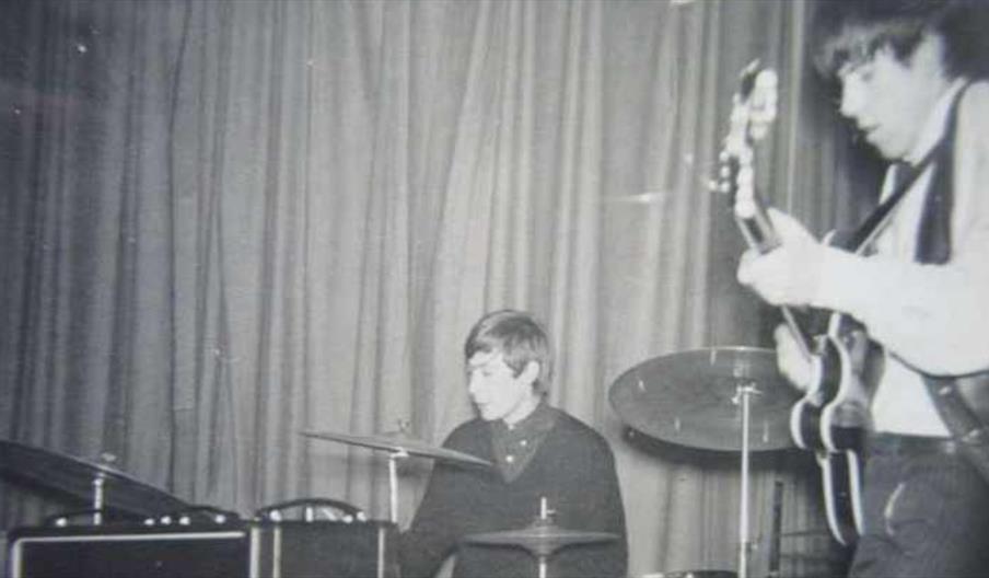 black and white photo of a band playing in the 1960s