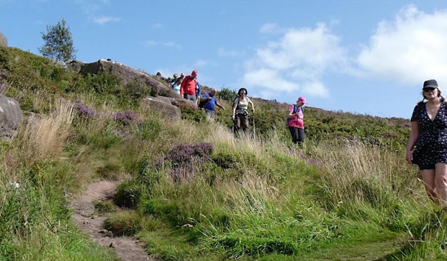 image of walkers over rocky terrain