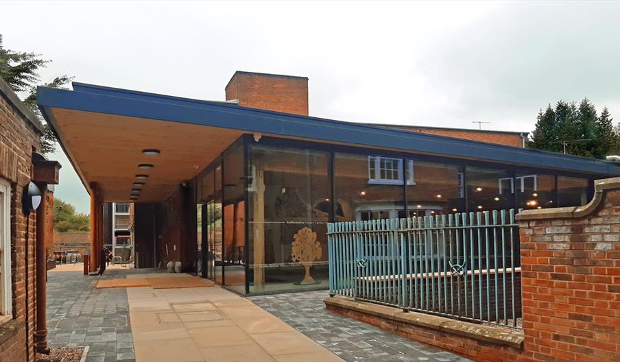 View of exterior of the Staffordshire History Centre showing pathway to the entrance and glass front of building