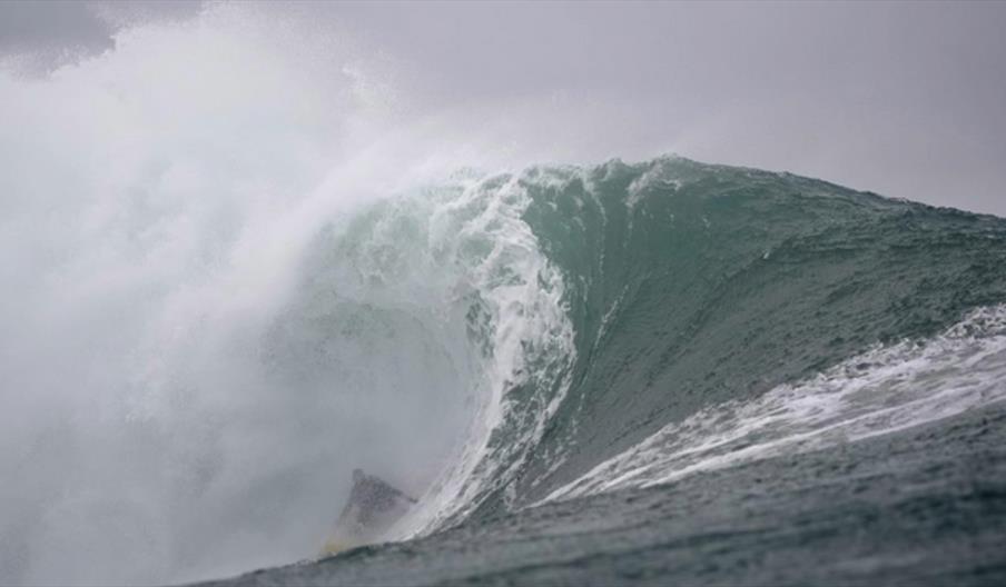 image of surfer in a big wave