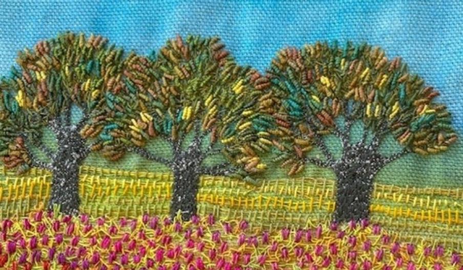Embroidery of trees, sky and flowers
