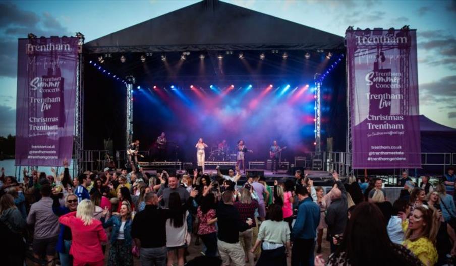 Acts perform on stage in front of a big crowd at The Trentham Estate, Staffordshire