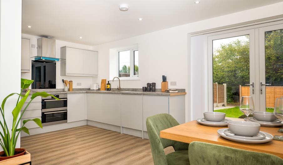 modern new build property kitchen with a dining table forte stays