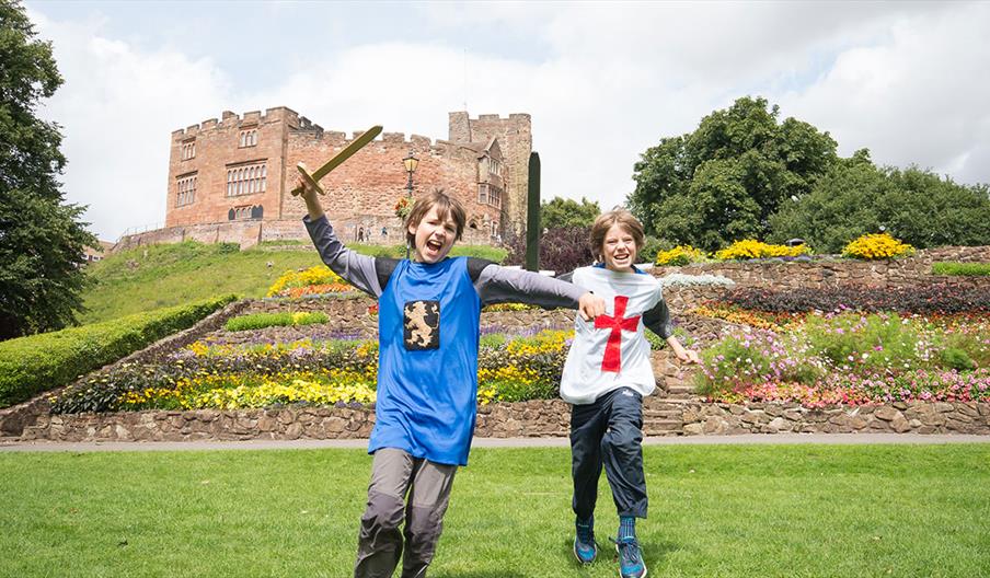 Tamworth Castle Pleasure Grounds, Tamworth, Staffordshire. Boys role playing knights in the grounds.