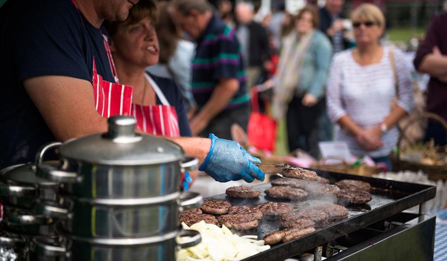 Stall holder cooking burgers at Tamworth Food Gusto Festival