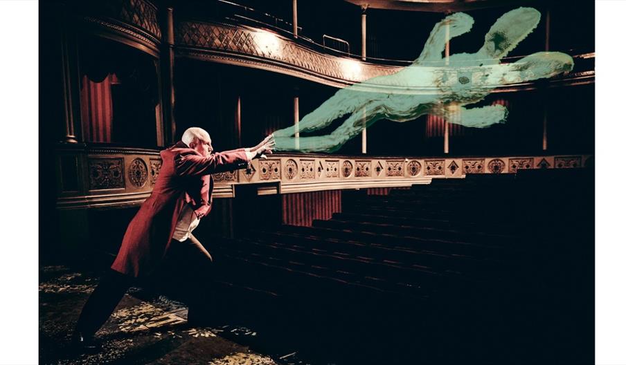 image of a magician on a theatre stage