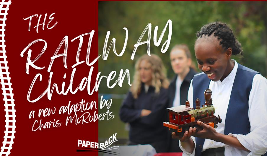 Promotional image for The Railway Children featuring a performer holding a toy train.