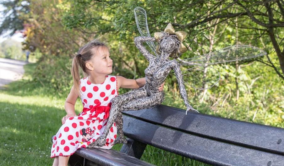 A young girl admires one of the Fairies at The Trentham Estate, Staffordshire