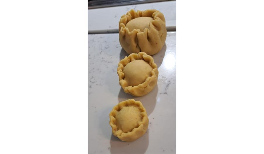 Handmade pork pies ready for baking.