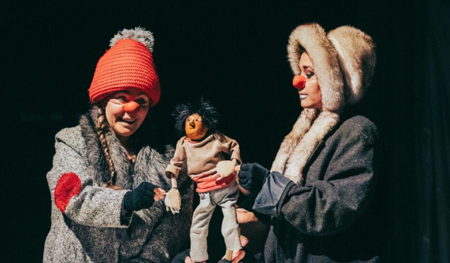 Artists performing with puppet