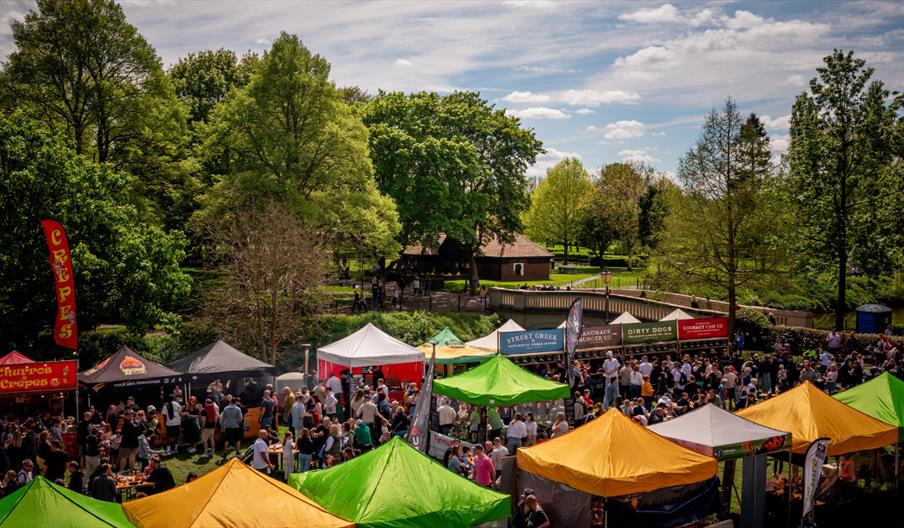 food festival with colourful market stalls and large crowds enjoying