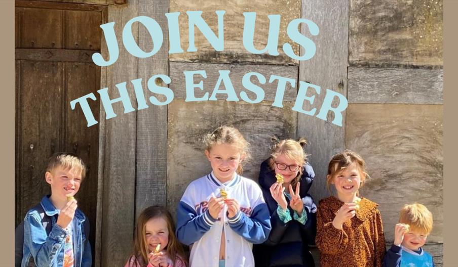 A group of children standing in front of a wooden building holding Easter treats, with the text “Join Us This Easter” displayed above them.