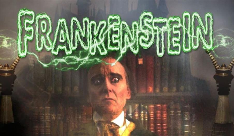 A dramatic promotional image for a stage adaptation of Frankenstein. The word “FRANKENSTEIN” appears at the top in glowing green letters with electric